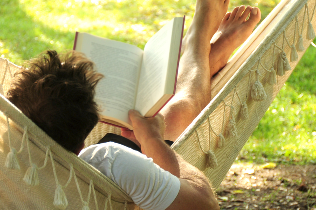 An individual relaxing in a peaceful environment, symbolizing the importance of rest and self-care.
