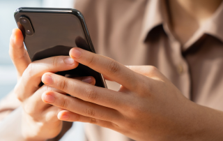A couple engaging with each other through their smartphones, symbolizing the intersection of social networking and online dating.