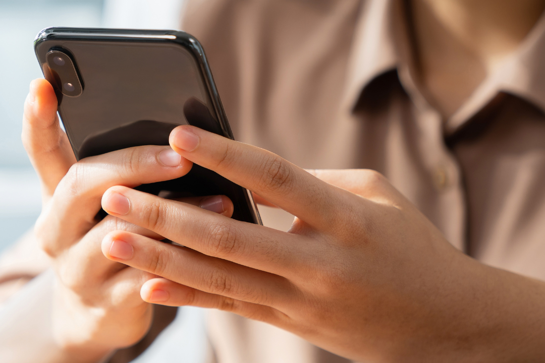 A couple engaging with each other through their smartphones, symbolizing the intersection of social networking and online dating.