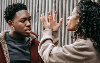 A couple engaging in a calm discussion, symbolizing effective conflict management strategies in relationships.
