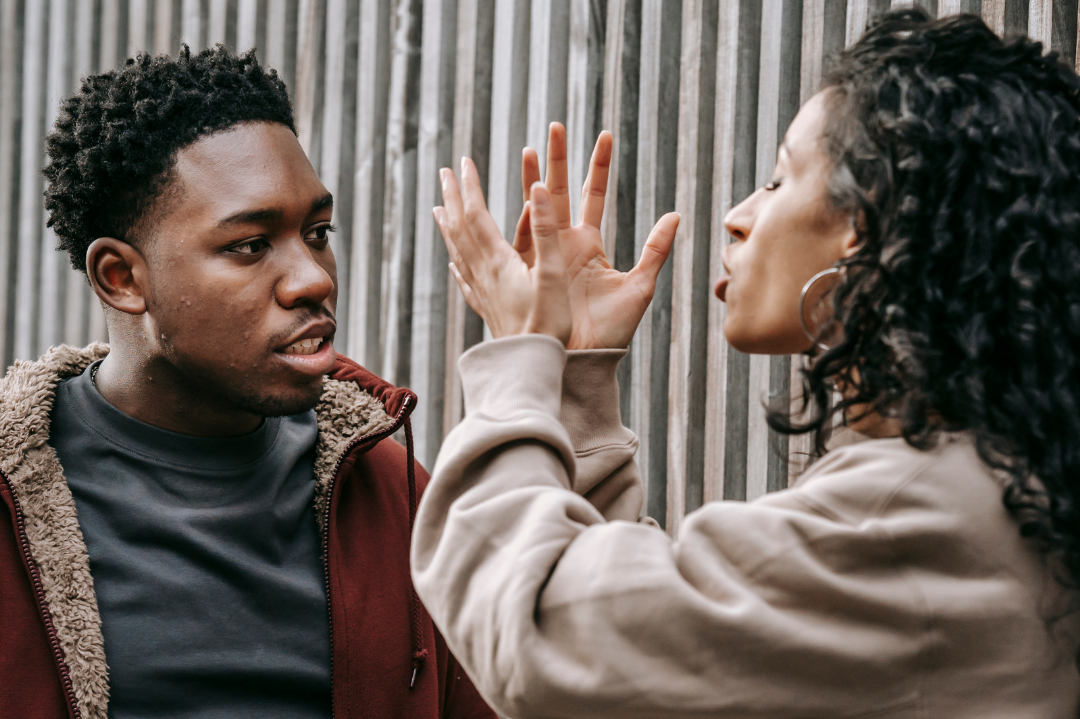 A couple engaging in a calm discussion, symbolizing effective conflict management strategies in relationships.