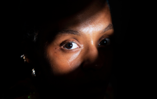 An individual reflecting deeply, symbolizing the personal and pervasive impact of trauma.