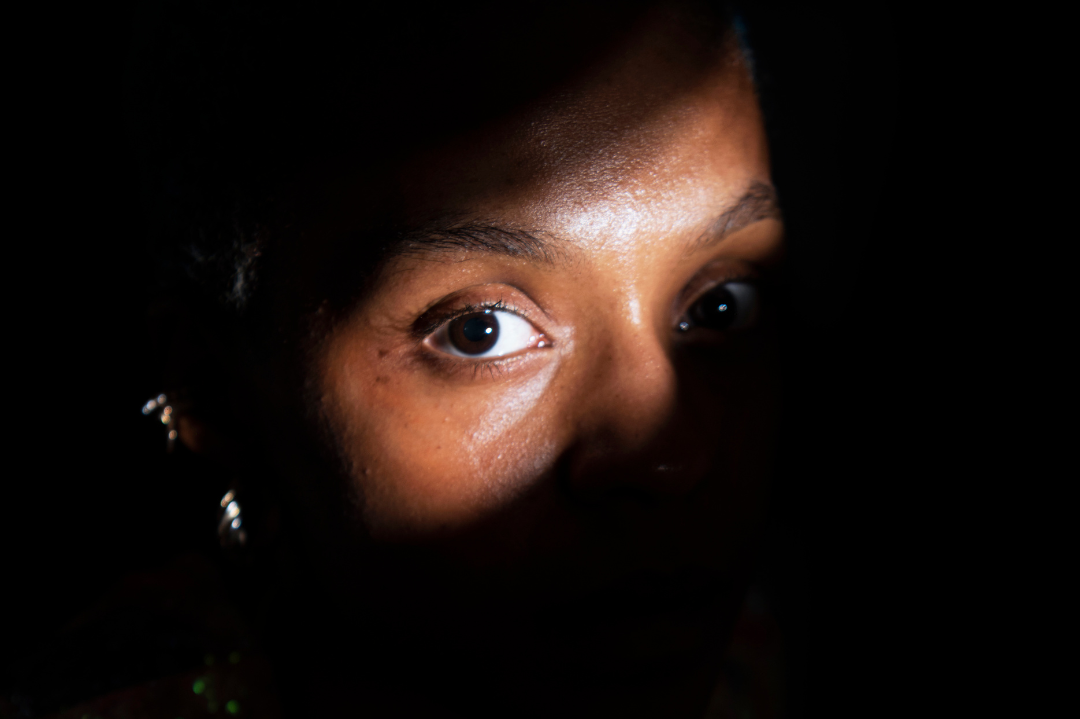 An individual reflecting deeply, symbolizing the personal and pervasive impact of trauma.