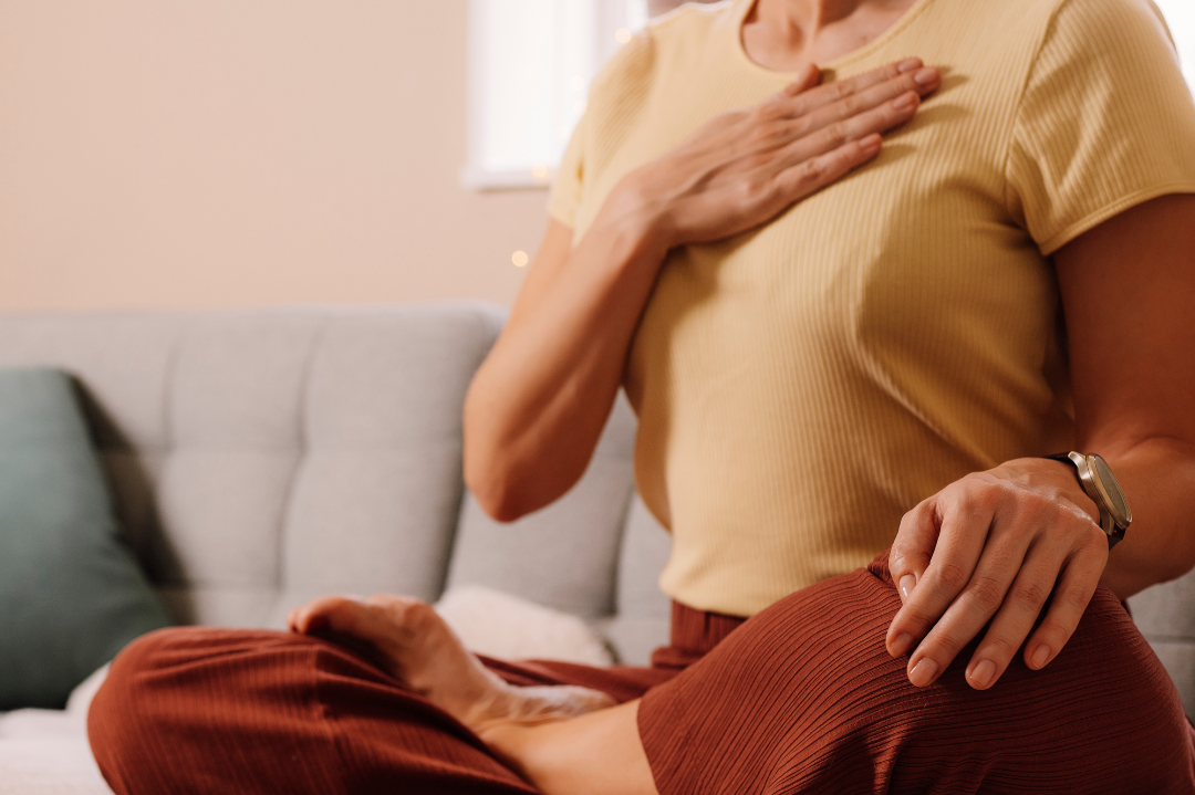 A person practicing deep breathing outdoors, symbolizing the holistic benefits of breathing exercises.
