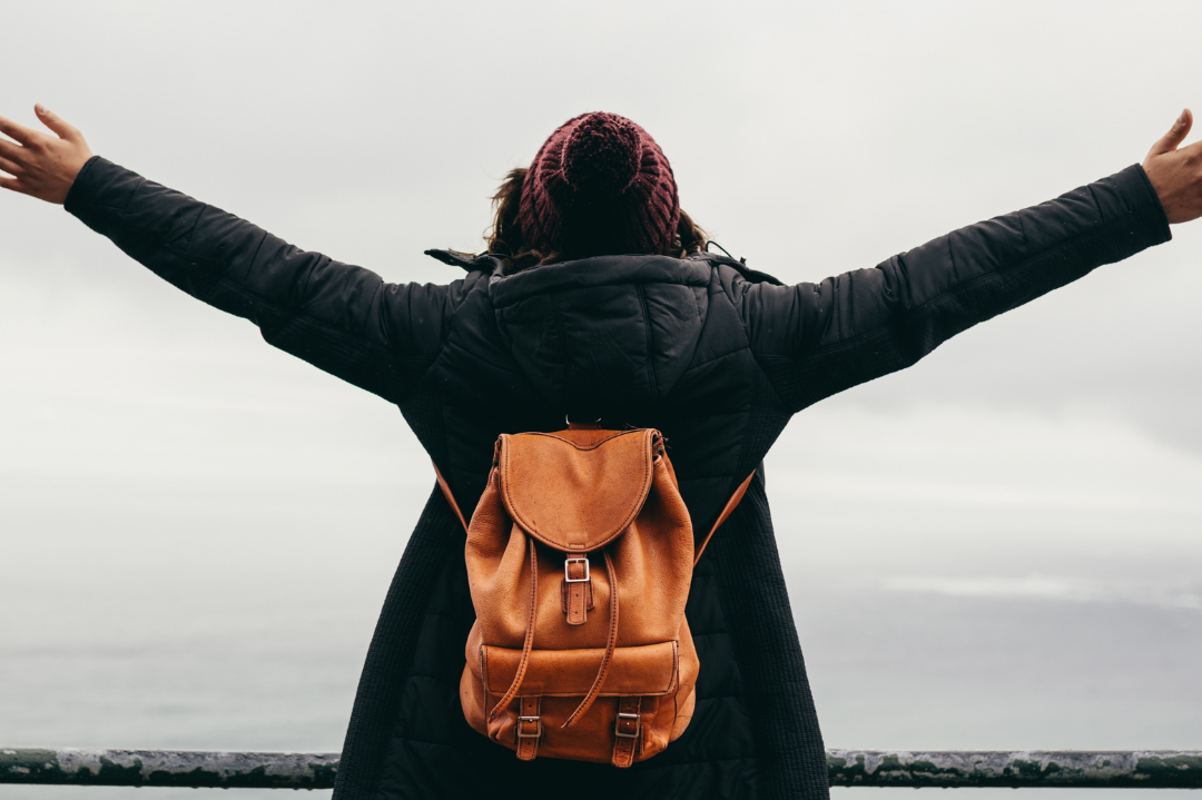 An individual standing confidently with open arms, symbolizing personal empowerment and freedom.