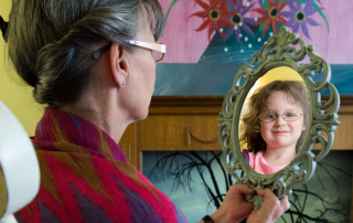 An individual embracing their younger self, symbolizing the healing of the inner child.