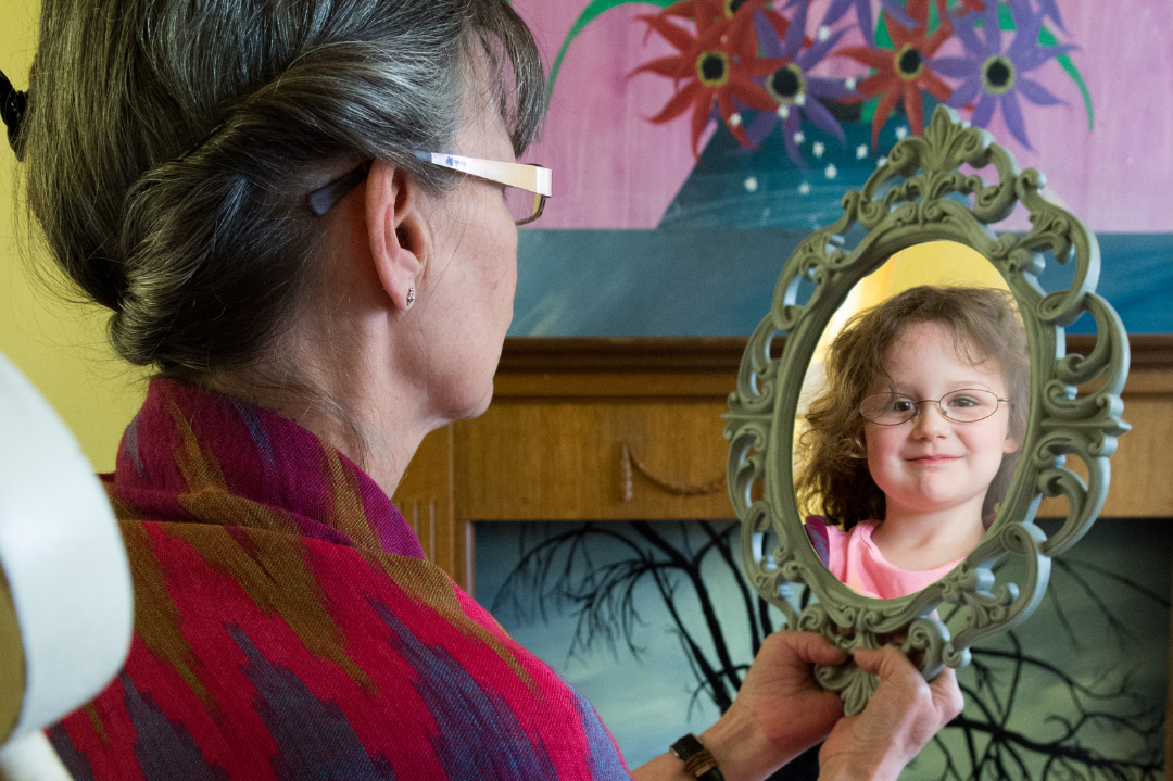 An individual embracing their younger self, symbolizing the healing of the inner child.