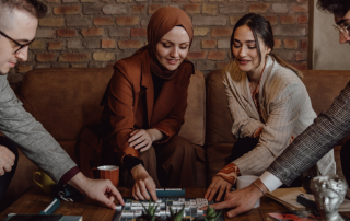Adults engaging in a playful activity, symbolizing the importance of play and creativity in enhancing well-being.