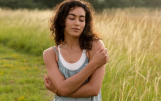An individual embracing themselves with kindness, symbolizing the journey of cultivating self-compassion in counselling.