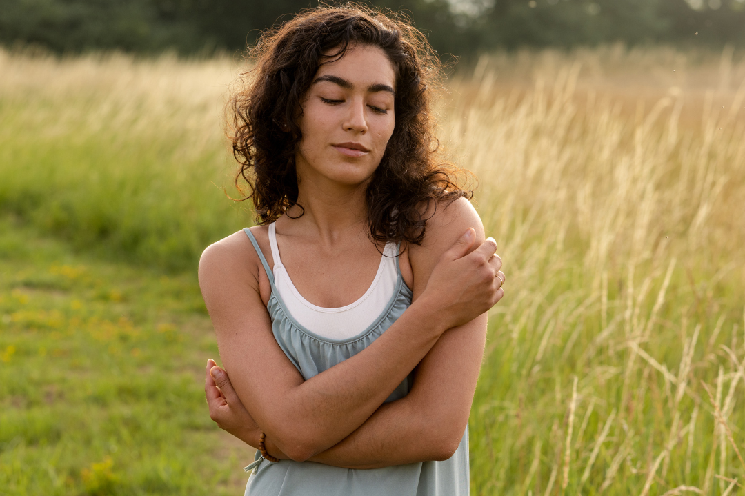 An individual embracing themselves with kindness, symbolizing the journey of cultivating self-compassion in counselling.