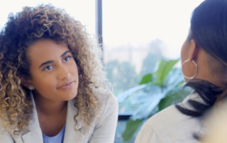 A counsellor attentively listening to a client, symbolizing the practice of active listening in a therapeutic setting.