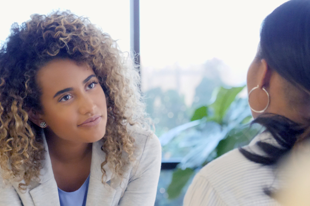 A counsellor attentively listening to a client, symbolizing the practice of active listening in a therapeutic setting.